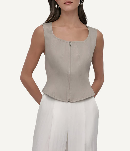 A beige, sleeveless, zip front seamed top by DKNY.