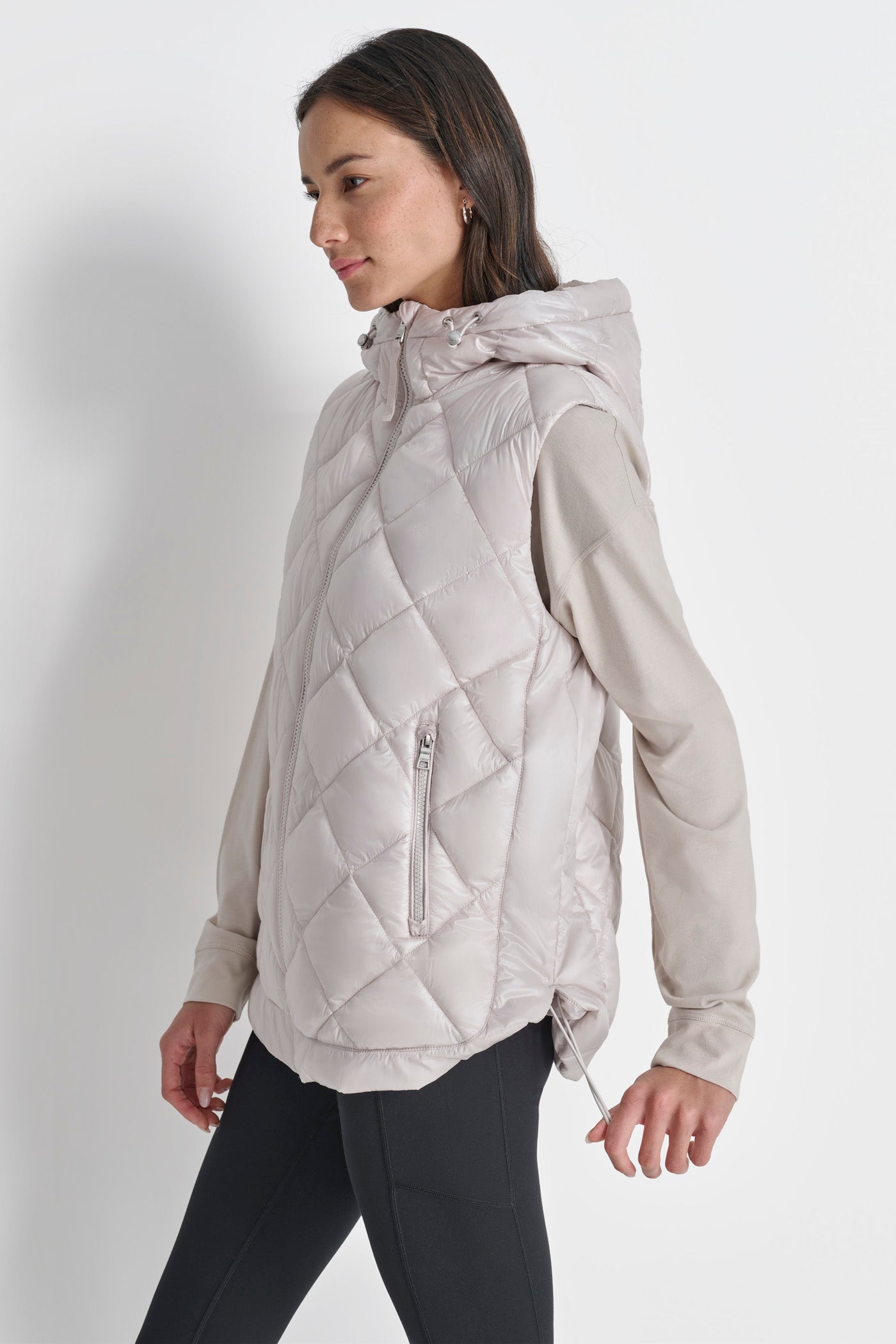 SLEEVELESS QUILTED CURVED HEM PUFFER VEST WITH HOOD